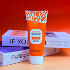 Close up of the Orange Enzyme Brightening Exfoliating Gel tube on a warm background